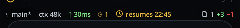 The status bar above the composer: the context figure, the latency, a queued count, an amber paused segment and the changed files.